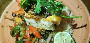 Chilean Sea Bass with Yucatan rice, roasted vegetables, and guajillo chimichurri