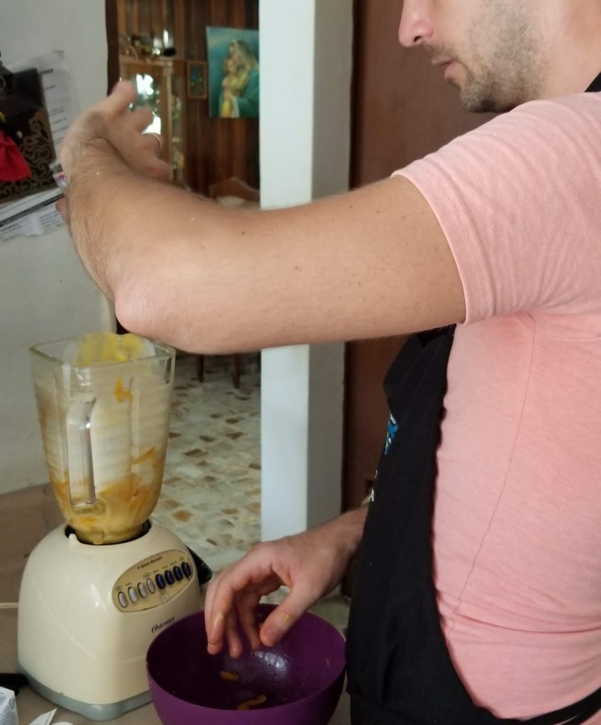Brandon pulverizes the mangoes in the blender