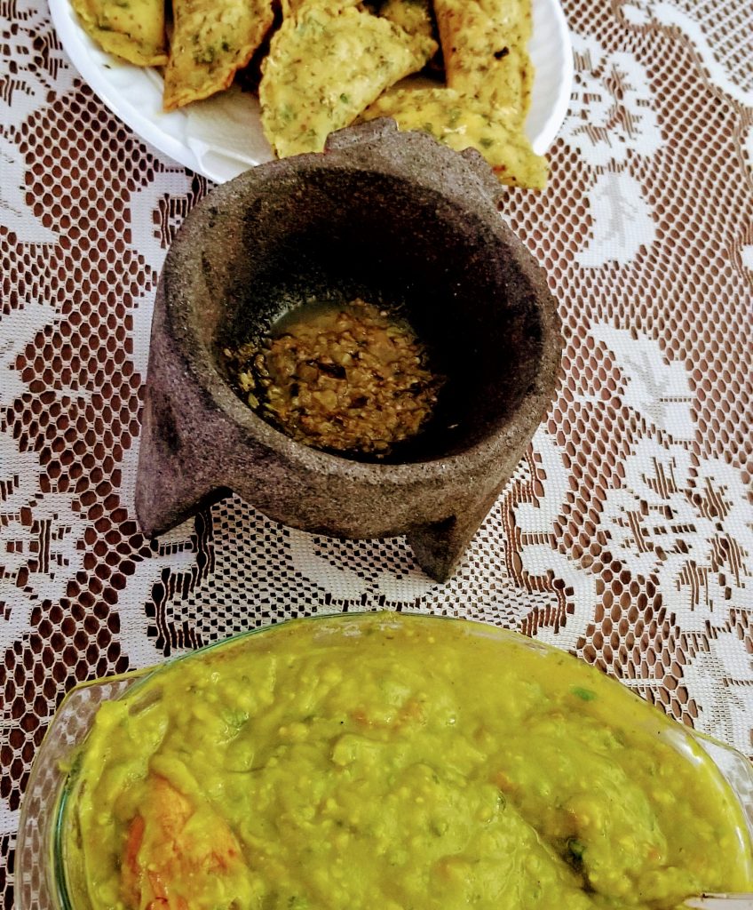 empanadas, hot sauce and guacamole