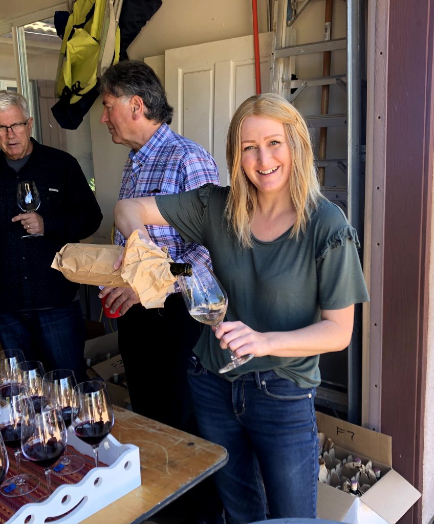 Allie Campbell pours the wine
