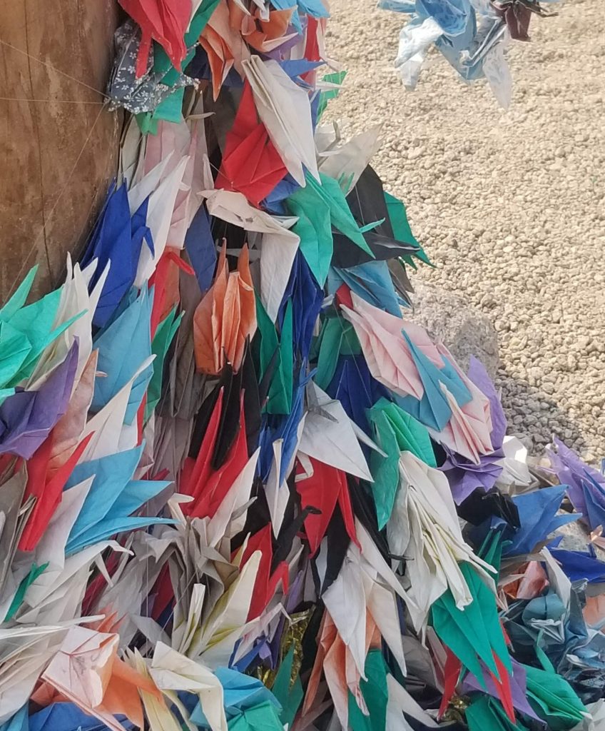 A multitude of origami cranes at the cemetery